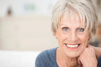 woman smiling with all-on-4 implants from Serenity Smiles