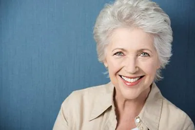 woman smiling with dentures from Serenity Smiles
