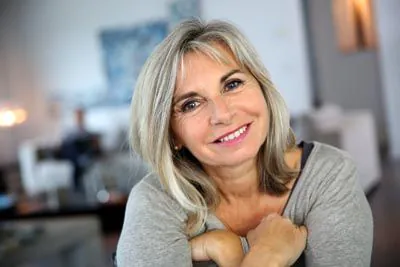 woman loving her restored smile from Serenity Smiles