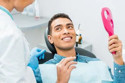 man loving his restored smile thanks to Serenity Smiles