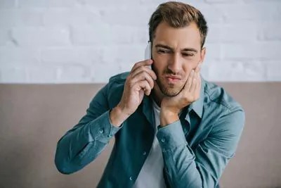 man calling Serenity Smiles for an emergency dental appointment