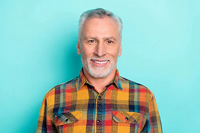 man smiling after restorative dental care from Serenity Smiles